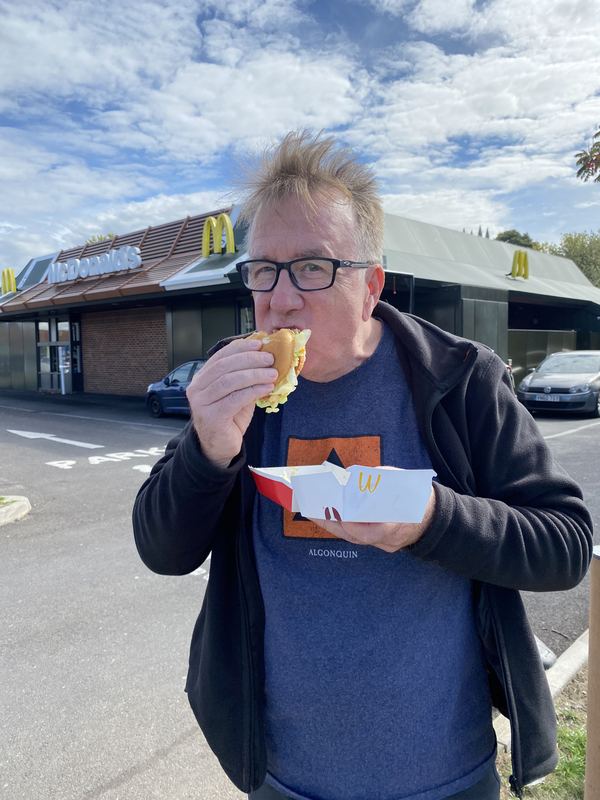 Supporter in the UK eating a Big Mac outside McDonald's