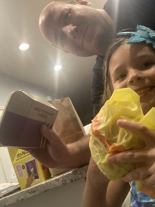 Grandparent and child biting into Big Macs