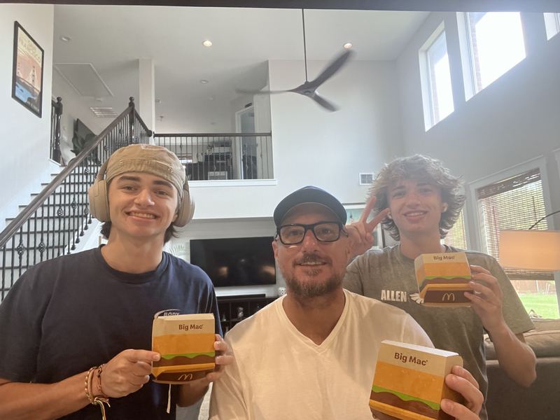 Three people with Big Mac boxes at home