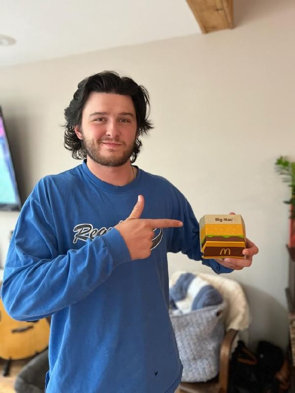 Supporter pointing at a Big Mac box