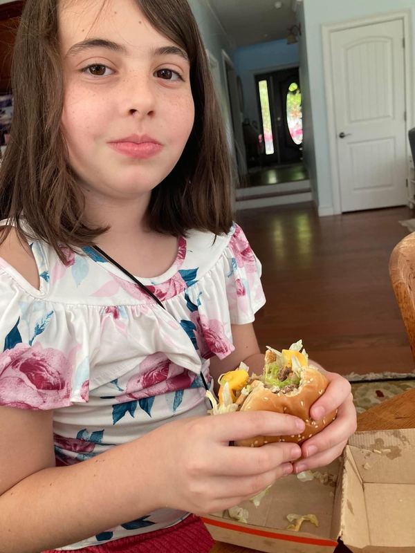 Young woman smiling with a Big Mac