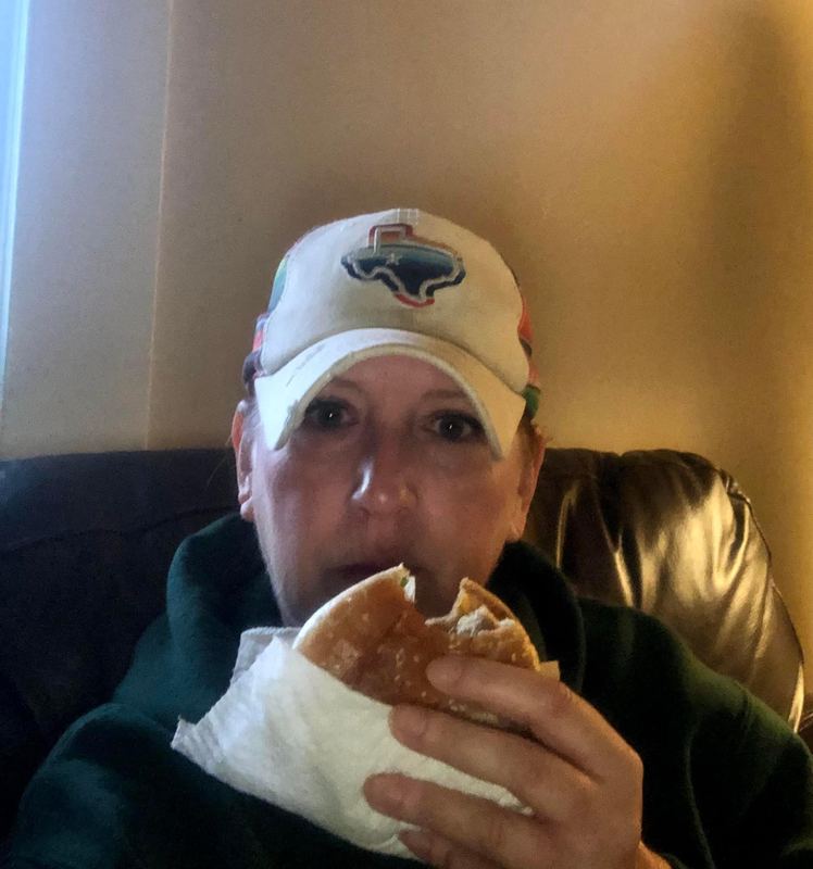 Supporter smiling with a Big Mac in a car