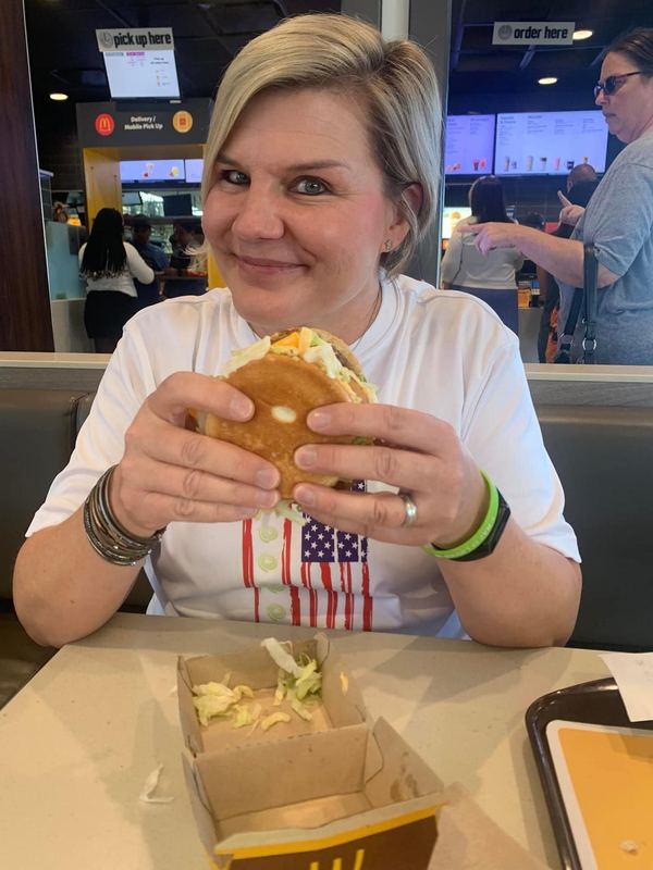 Supporter smiling with a Big Mac